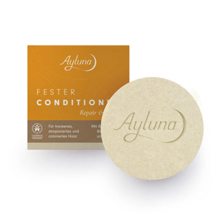 Ayluna Fester Conditioner Repair & Strengthening hair treatment, showing the orange and brown product box alongside a round beige hair mask with the Ayluna logo embossed on it, set against a clean white background.