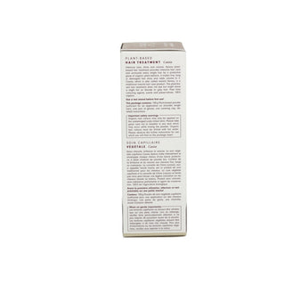 The back of a tall white cardboard box for a plant-based hair treatment, featuring black text and two product sections, photographed against a plain white background.