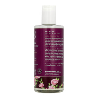 A bottle of traditional German shampoo for hair and haircare, featuring a white cap and a dark purple label with pink rose illustrations at the bottom.
