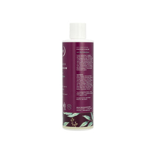 A bottle of Rosemary Hair Growth Serum shown from the back, featuring a deep purple label with white text and botanical illustrations, topped with a white cap, on a solid white background.