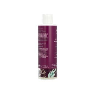 A bottle of Aesop Brown Bar soap, shown from the back, featuring a deep plum purple label with white text and botanical illustrations at the bottom, topped with a white cap, on a solid white background.